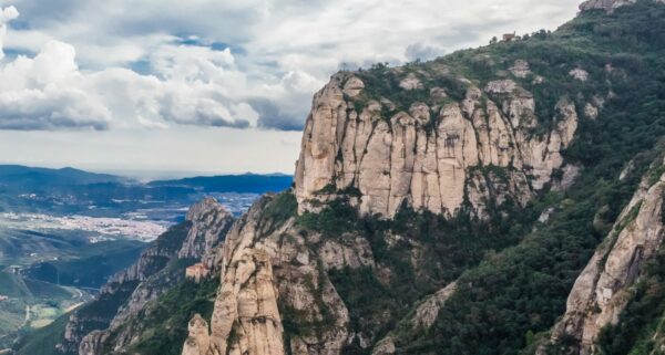 Scenic view of Montserrat's unique rock formations and greenery under a blue sky